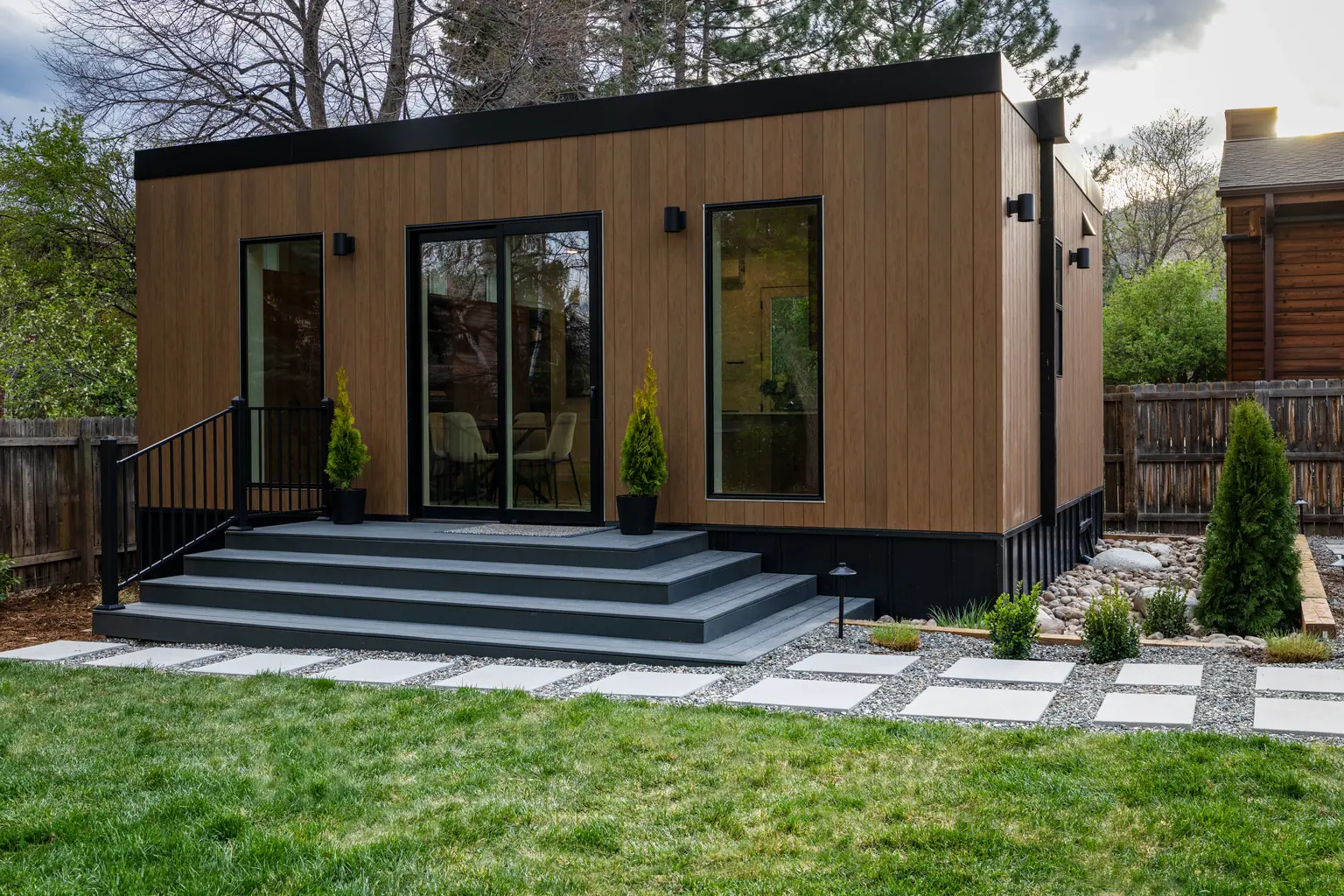 Finished Olerra ADU with warm wood cladding in a landscaped Colorado backyard