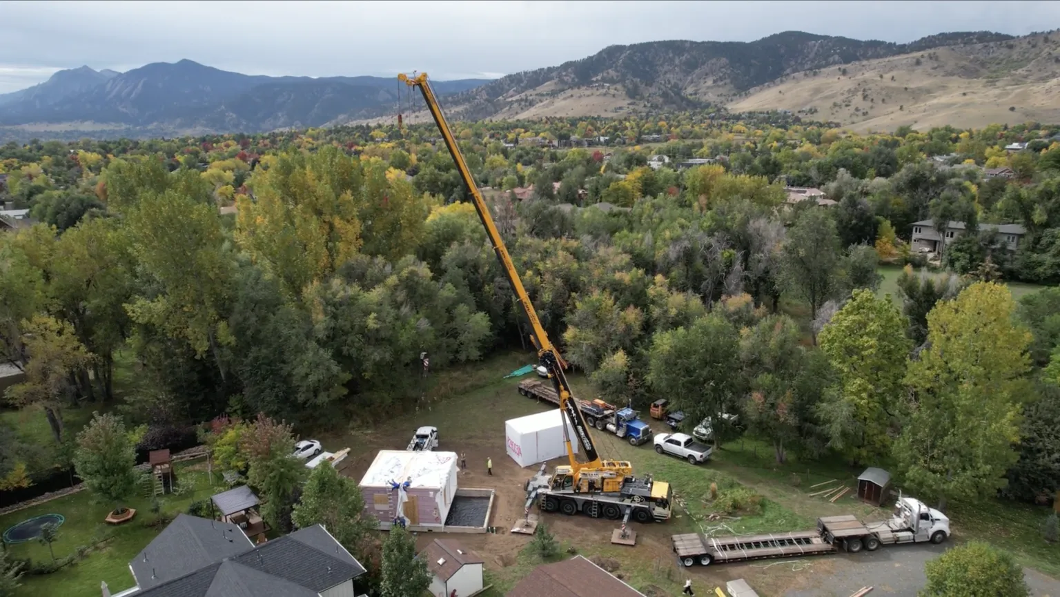 Crane lowering a finished Olerra Flex-Flat into a Boulder backyard on install day